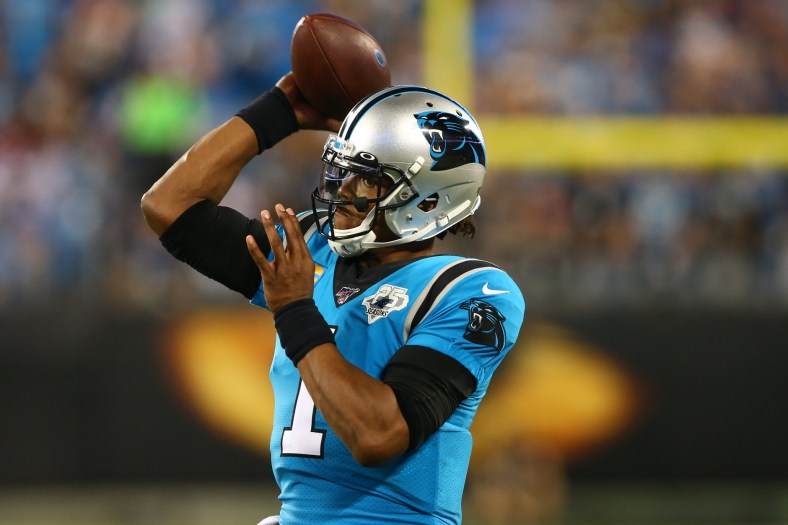 Cam Newton throws pass during NFL game