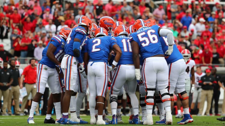 Florida Gators football players huddle