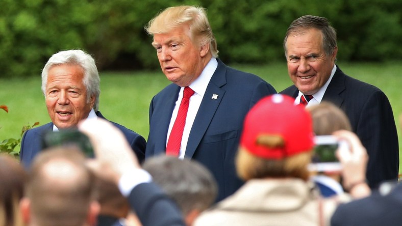 President Donald Trump stands with NFL owner Robert Kraft and HC Bill Belichick
