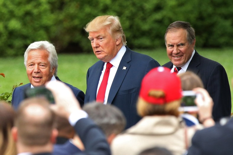 President Donald Trump stands with NFL owner Robert Kraft and HC Bill Belichick
