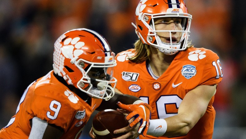 Clemson QB Trevor Lawrence hands ball to RB Travis Etienne