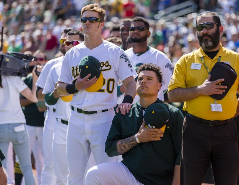 Oakland Athletics catcher Bruce Maxwell kneels during national anthem