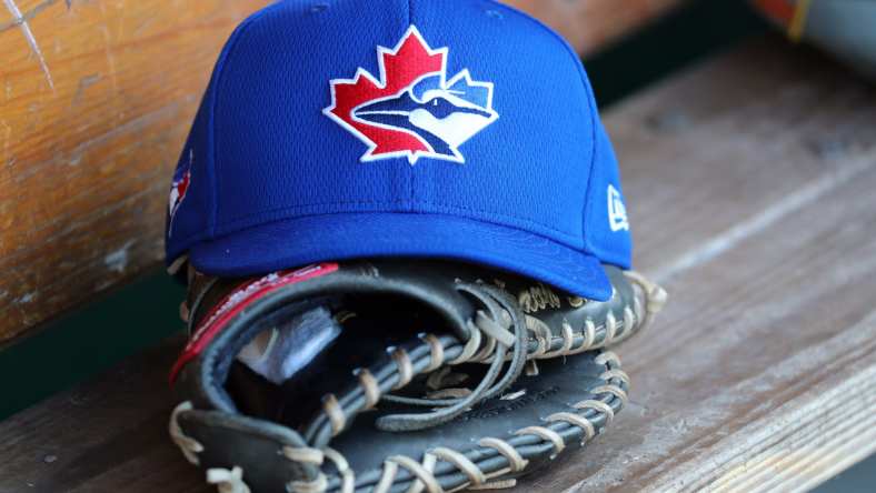 Toronto Blue Jays hat and helmet in dugout