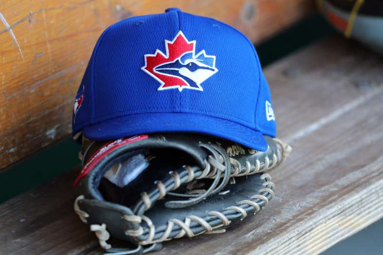Toronto Blue Jays hat and helmet in dugout