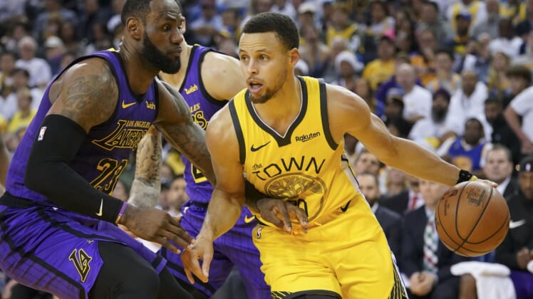 Warriors Stephen Curry goes up against Lakers' LeBron James