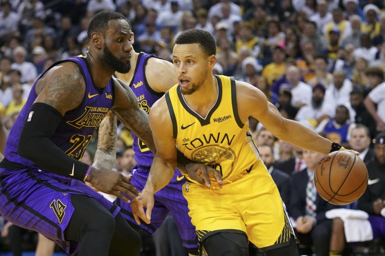 Warriors Stephen Curry goes up against Lakers' LeBron James