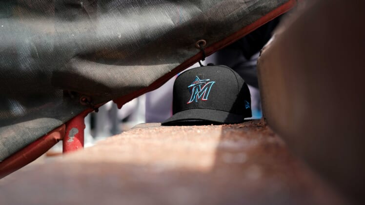 Marlins hat during MLB game against the Reds.