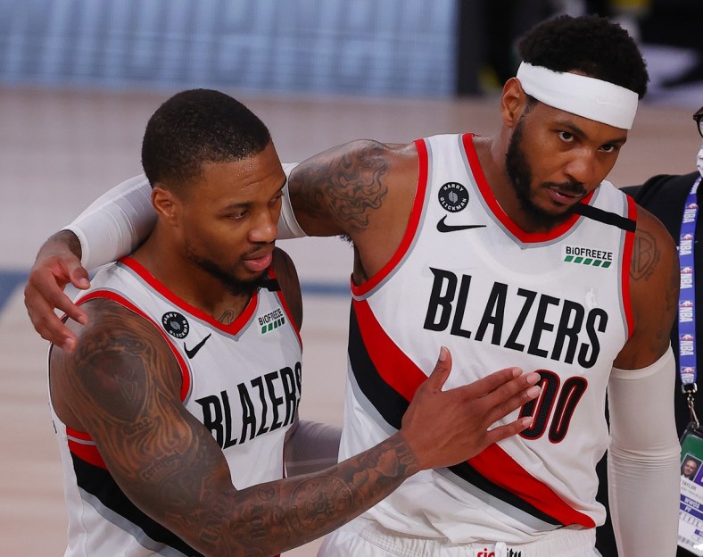 Carmelo Anthony and Damian Lillard during NBA game against 76ers.