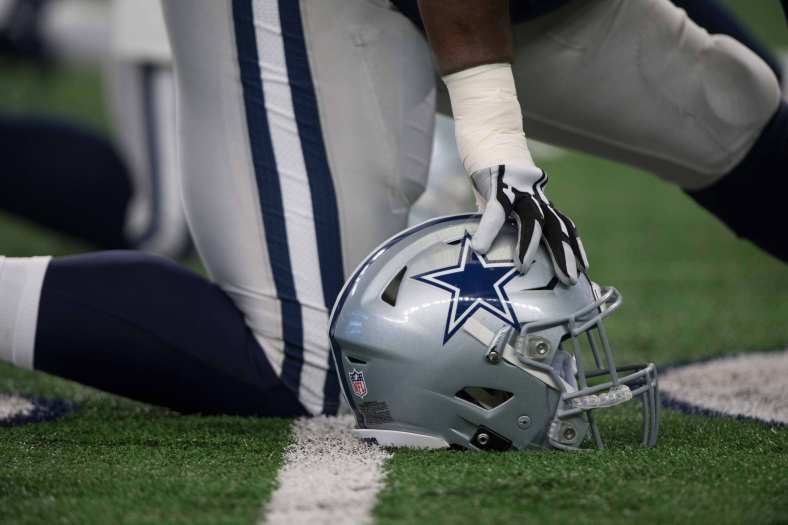 Dallas Cowboys helmet as player takes a knee