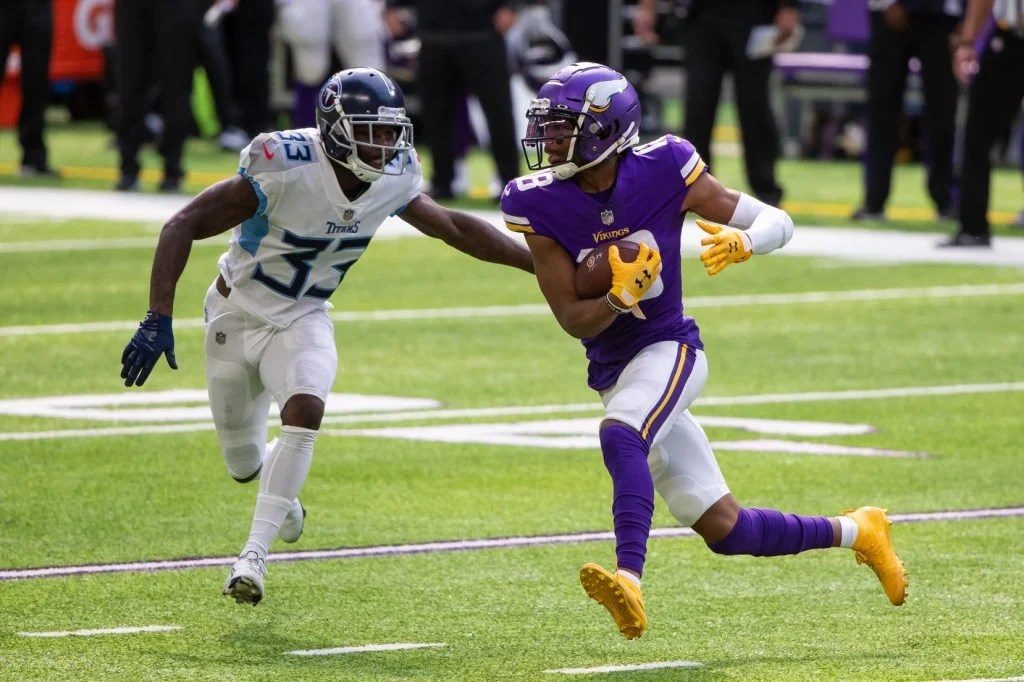 Sep 27, 2020; Minneapolis, Minnesota, USA; Minnesota Vikings wide receiver Justin Jefferson (18) runs after the catch in the second quarter against the Tennessee Titans defensive back Johnathan Joseph (33) at U.S. Bank Stadium. Mandatory Credit: Brad Rempel-USA TODAY Sports