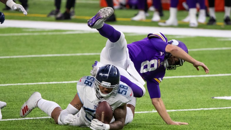 Sep 27, 2020; Minneapolis, Minnesota, USA; Tennessee Titans linebacker Harold Landry (58) tries to recover the Minnesota Vikings quarterback Kirk Cousins (8) fumble in the fourth quarter at U.S. Bank Stadium. Mandatory Credit: Brad Rempel-USA TODAY Sports