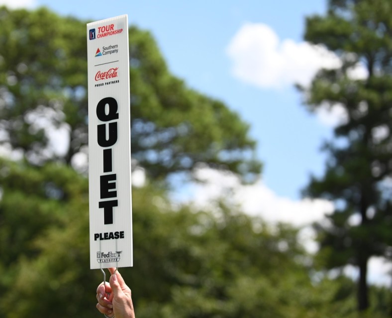 Aug 22, 2019; Atlanta, GA, USA; A marshall holds up a quiet sign during the first round of the Tour Championship golf tournament at East Lake Golf Club. Mandatory Credit: Adam Hagy-USA TODAY Sports