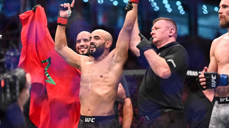 Sep 7, 2019; Abu Dhabi, UAE; Ottman Azaitar (red gloves) celebrates after defeating Teemu Packalen (blue gloves) during UFC 242 at The Arena. Mandatory Credit: Per Haljestam-USA TODAY Sports