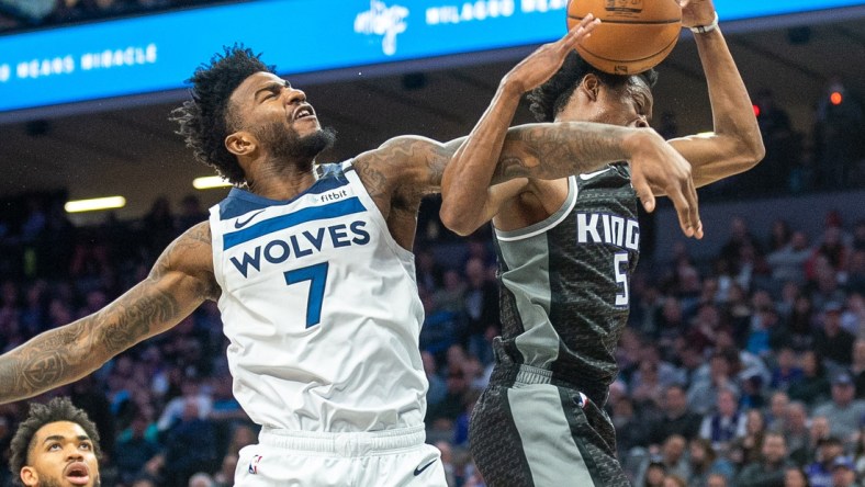 Feb 3, 2020; Sacramento, California, USA; Minnesota Timberwolves forward Jordan Bell (7) blocks a shot by Sacramento Kings guard De'Aaron Fox (5) during the fourth quarter at Golden 1 Center. Mandatory Credit: Ed Szczepanski-USA TODAY Sports