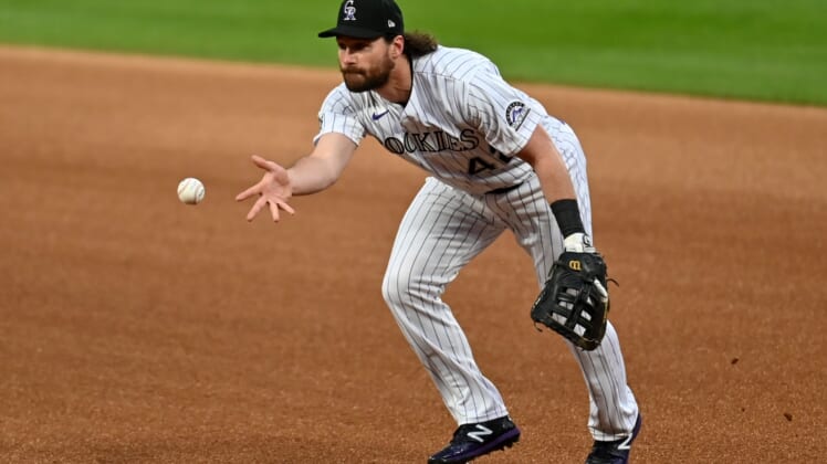 Aug 28, 2020; Denver, Colorado, USA; Colorado Rockies first baseman Daniel Murphy (9) fields the ball in the first inning against the San Diego Padres at Coors Field. Mandatory Credit: Ron Chenoy-USA TODAY Sports
