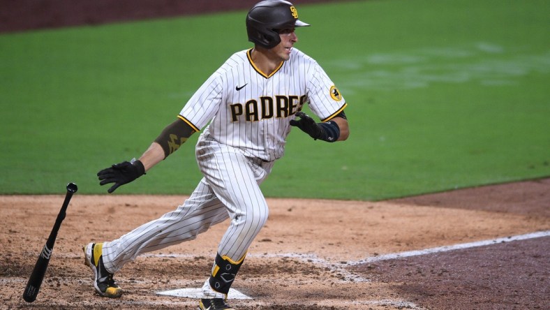 Sep 8, 2020; San Diego, California, USA; San Diego Padres catcher Jason Castro (11) hits a double during the seventh inning against the Colorado Rockies at Petco Park. Mandatory Credit: Orlando Ramirez-USA TODAY Sports