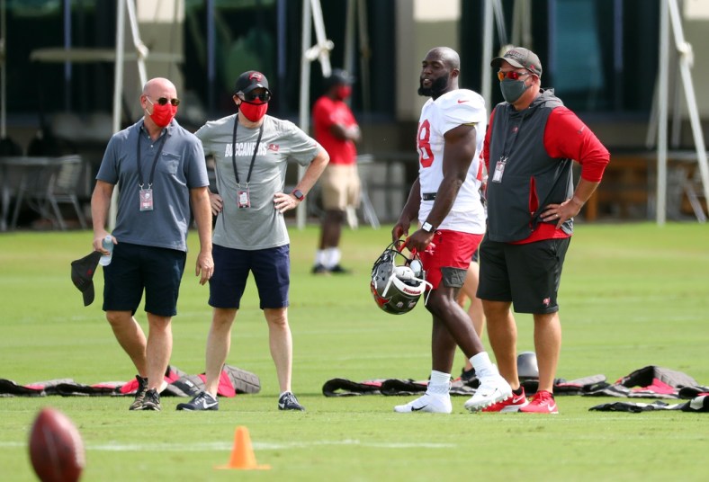 Sep 9, 2020; Tampa, Florida, United States;Tampa Bay Buccaneers running back Leonard Fournette (28) talks with general manager Jason Licht, owner Joel Glazer and owner Bryan Glazer at AdventHealth Training Center. Mandatory Credit: Kim Klement-USA TODAY Sports