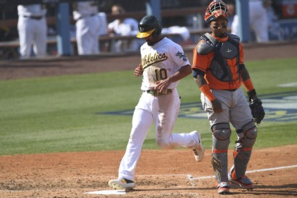 Oct 5, 2020; Los Angeles, California, USA; Oakland Athletics shortstop Marcus Semien (10) scores on a sacrifice fly by right fielder Mark Canha (not pictured) against Houston Astros catcher Martin Maldonado (right) during the fifth inning in game one of the 2020 ALDS at Dodger Stadium. Mandatory Credit: Jayne Kamin-Oncea-USA TODAY Sports