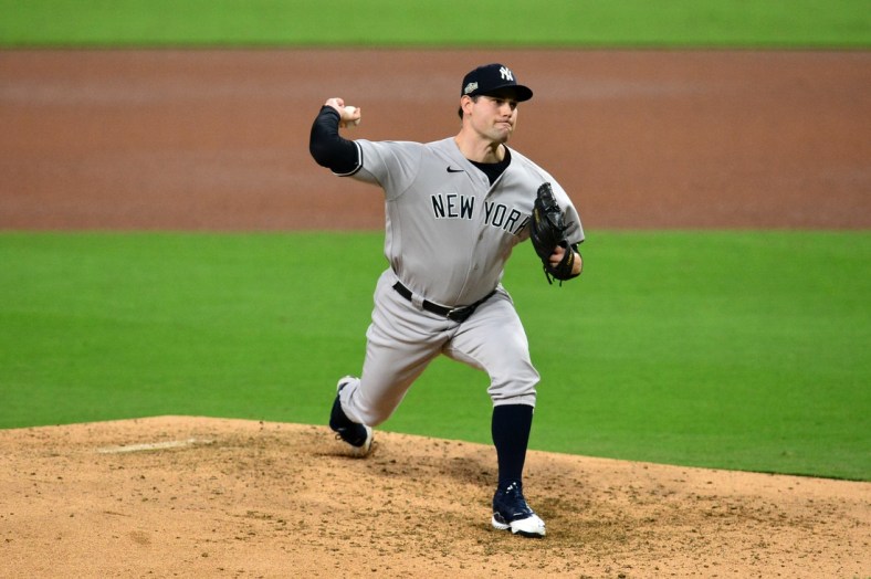 Oct 6, 2020; San Diego, California, USA; New York Yankees relief pitcher Adam Ottavino (0) delivers a pitch in the 4th inning against the Tampa Bay Rays during game two of the 2020 ALDS at Petco Park. Mandatory Credit: Gary A. Vasquez-USA TODAY Sports