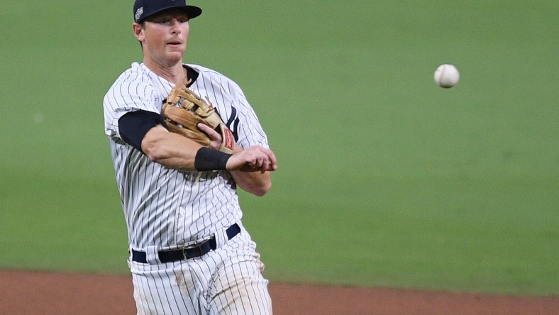 Oct 8, 2020; San Diego, California, USA; New York Yankees second baseman DJ LeMahieu (26) throws to first base to retire Tampa Bay Rays shortstop Willy Adames (not pictured) during the seventh inning of game four of the 2020 ALDS at Petco Park. Mandatory Credit: Orlando Ramirez-USA TODAY Sports