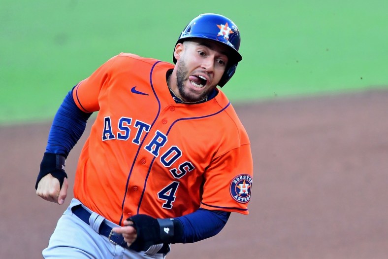 Oct 16, 2020; San Diego, California, USA; Houston Astros center fielder George Springer (4) rounds third base with his tongue out on his way to score against the Tampa Bay Rays on an RBI double hit by second baseman Jose Altuve (not pictured) during the fifth inning during game six of the 2020 ALCS at Petco Park. Mandatory Credit: Jayne Kamin-Oncea-USA TODAY Sports