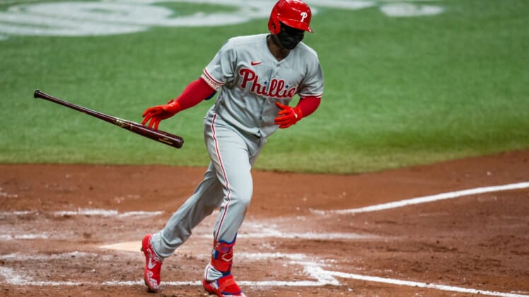 Sep 26, 2020; St. Petersburg, Florida, USA; Philadelphia Phillies shortstop Didi Gregorius (18) flips his bat as he runs to first base during a game against the Tampa Bay Rays at Tropicana Field. Mandatory Credit: Mary Holt-USA TODAY Sports