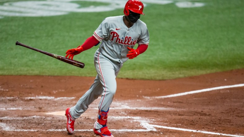 Sep 26, 2020; St. Petersburg, Florida, USA; Philadelphia Phillies shortstop Didi Gregorius (18) flips his bat as he runs to first base during a game against the Tampa Bay Rays at Tropicana Field. Mandatory Credit: Mary Holt-USA TODAY Sports