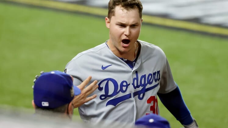 Oct 25, 2020; Arlington, Texas, USA; Los Angeles Dodgers left fielder Joc Pederson (31) is congratulated as he enters the dugout after hitting a home run against the Tampa Bay Rays during the first inning during game five of the 2020 World Series at Globe Life Field. Mandatory Credit: Kevin Jairaj-USA TODAY Sports