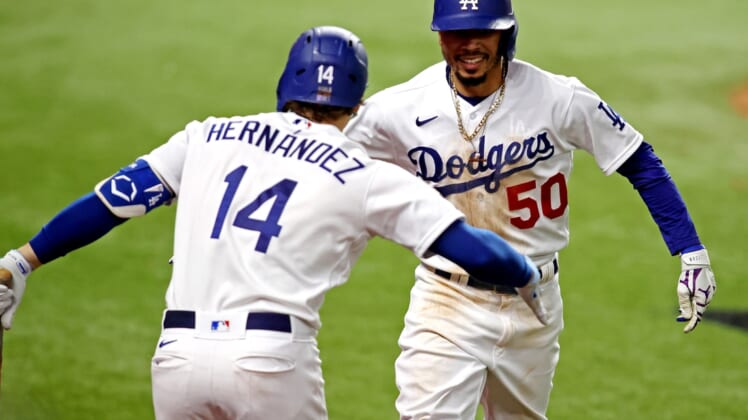 Oct 27, 2020; Arlington, Texas, USA;  Los Angeles Dodgers right fielder Mookie Betts (50) celebrates with second baseman Enrique Hernandez (14) after hitting a home run during the eighth inning against the Tampa Bay Rays during game six of the 2020 World Series at Globe Life Field. Mandatory Credit: Tim Heitman-USA TODAY Sports