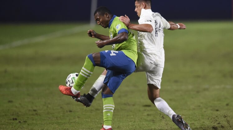 Nov 4, 2020; Carson, California, USA; LA Galaxy forward Javier Hern  ndez (14) battles for the ball with Seattle Sounders FC defender Jimmy Medranda (94) during the second half at Dignity Health Sports Park. Mandatory Credit: Kelvin Kuo-USA TODAY Sports