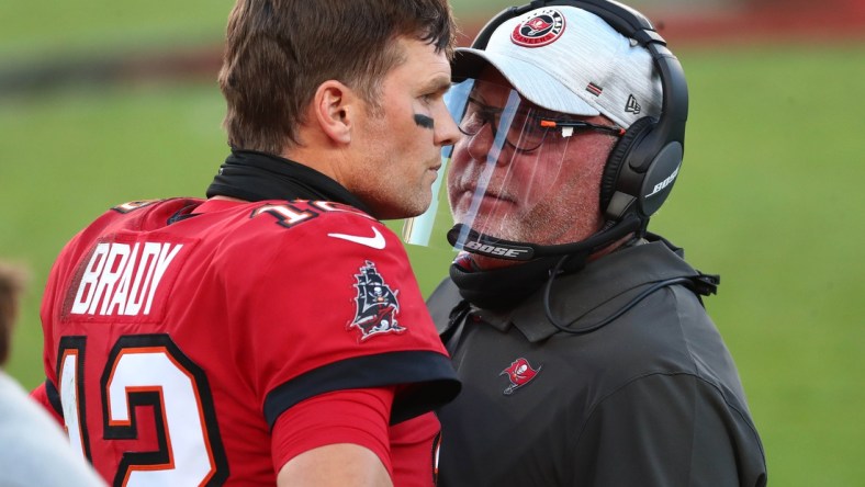 Nov 29, 2020; Tampa, Florida, USA; Tampa Bay Buccaneers head coach Bruce Arians speaks with Tampa Bay Buccaneers quarterback Tom Brady (12) during the first half at Raymond James Stadium. Mandatory Credit: Kim Klement-USA TODAY Sports