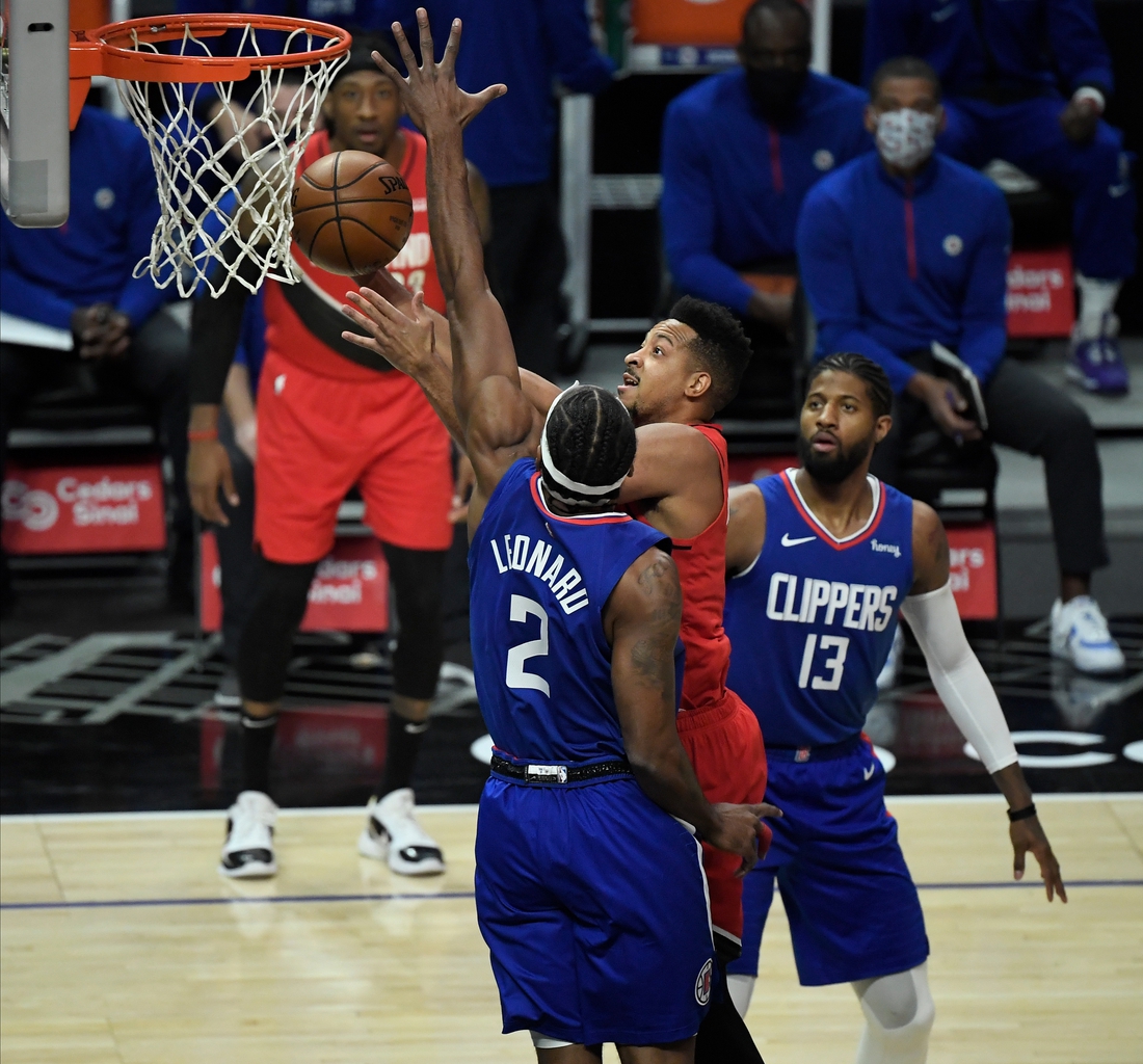 Dec 30, 2020; Los Angeles, California, USA; Portland Trail Blazers guard CJ McCollum (3) drives to the basket between LA Clippers forward Kawhi Leonard (2) and guard Paul George (13) in the first quarter at Staples Center. Mandatory Credit: Robert Hanashiro-USA TODAY Sports