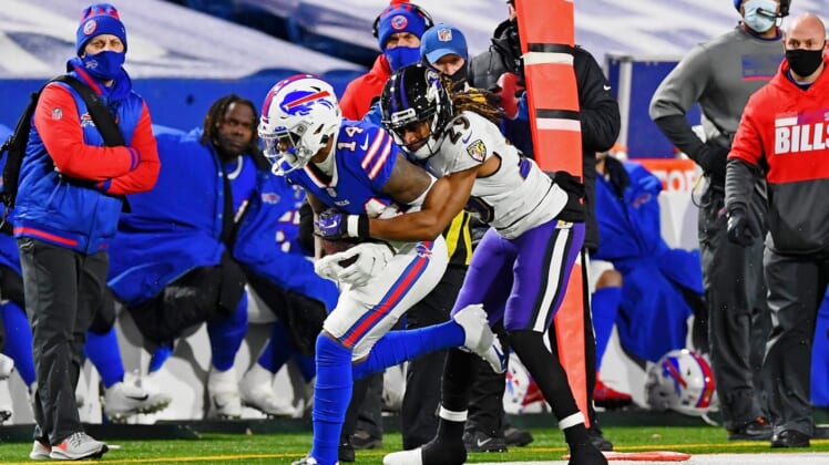 Jan 16, 2021; Orchard Park, New York, USA; Baltimore Ravens cornerback Tramon Williams (29) tackles Buffalo Bills wide receiver Stefon Diggs (14) during the second half of an AFC Divisional Round playoff game at Bills Stadium. Mandatory Credit: Rich Barnes-USA TODAY Sports