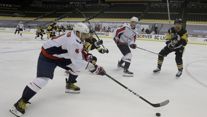 Jan 17, 2021; Pittsburgh, Pennsylvania, USA;  Washington Capitals left wing Alex Ovechkin (8) carries the puck against the Pittsburgh Penguins during the second period at the PPG Paints Arena. Mandatory Credit: Charles LeClaire-USA TODAY Sports