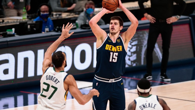 Jan 17, 2021; Denver, Colorado, USA; Denver Nuggets center Nikola Jokic (15) attempts a shot as Utah Jazz center Rudy Gobert (27) defends in the fourth quarter at Ball Arena. Mandatory Credit: Isaiah J. Downing-USA TODAY Sports