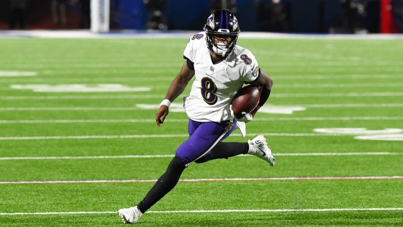 Jan 16, 2021; Orchard Park, New York, USA; Baltimore Ravens quarterback Lamar Jackson (8) runs with the ball against the Buffalo Bills during the third quarter of an AFC Divisional Round game at Bills Stadium. Mandatory Credit: Rich Barnes-USA TODAY Sports