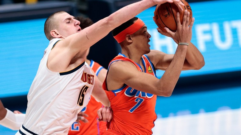 Jan 19, 2021; Denver, Colorado, USA; Denver Nuggets center Nikola Jokic (15) knocks the ball away from Oklahoma City Thunder forward Darius Bazley (7) in the third quarter at Ball Arena. Mandatory Credit: Isaiah J. Downing-USA TODAY Sports