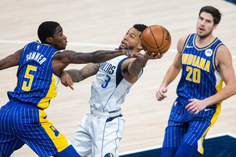 Jan 20, 2021; Indianapolis, Indiana, USA; Dallas Mavericks guard Trey Burke (3) shoots the ball while Indiana Pacers guard Edmond Sumner (5) defends in the third quarter at Bankers Life Fieldhouse. Mandatory Credit: Trevor Ruszkowski-USA TODAY Sports