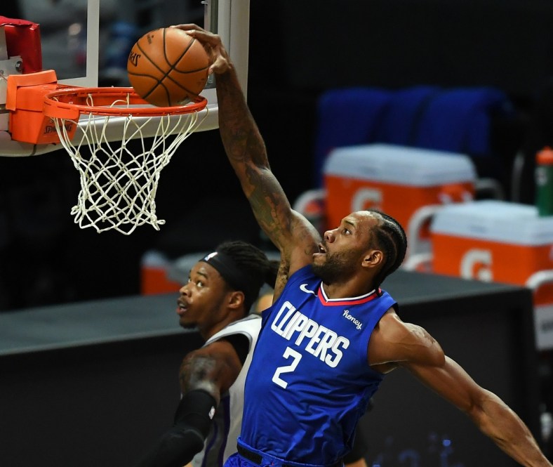 Jan 20, 2021; Los Angeles, California, USA; Los Angeles Clippers forward Kawhi Leonard (2) gets past Sacramento Kings center Richaun Holmes (22) for a dunk in the first half of the game at Staples Center. Mandatory Credit: Jayne Kamin-Oncea-USA TODAY Sports