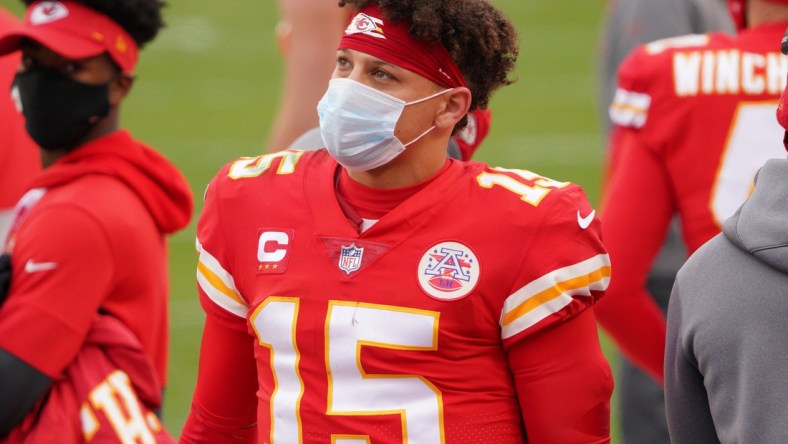 Jan 17, 2021; Kansas City, Missouri, USA; Kansas City Chiefs quarterback Patrick Mahomes (15) watches play on the sidelines during the AFC Divisional Round playoff game against the Cleveland Browns at Arrowhead Stadium. Mandatory Credit: Denny Medley-USA TODAY Sports