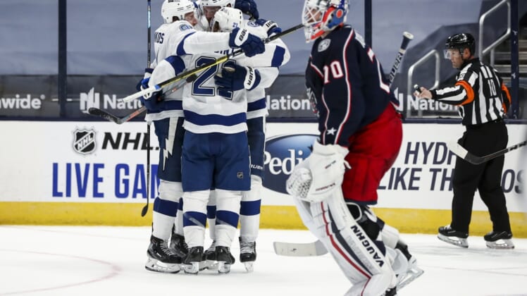 Jan 21, 2021; Columbus, Ohio, USA; Tampa Bay Lightning center Brayden Point (21) celebrates with teammates after scoring the game-winning goal against the Columbus Blue Jackets in the overtime period at Nationwide Arena. Mandatory Credit: Aaron Doster-USA TODAY Sports