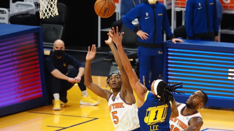 Jan 21, 2021; San Francisco, California, USA; Golden State Warriors guard-forward Damion Lee (1) shoots the ball between New York Knicks guard Immanuel Quickley (5) and guard Alec Burks (18) during the second quarter at Chase Center. Mandatory Credit: Kelley L Cox-USA TODAY Sports