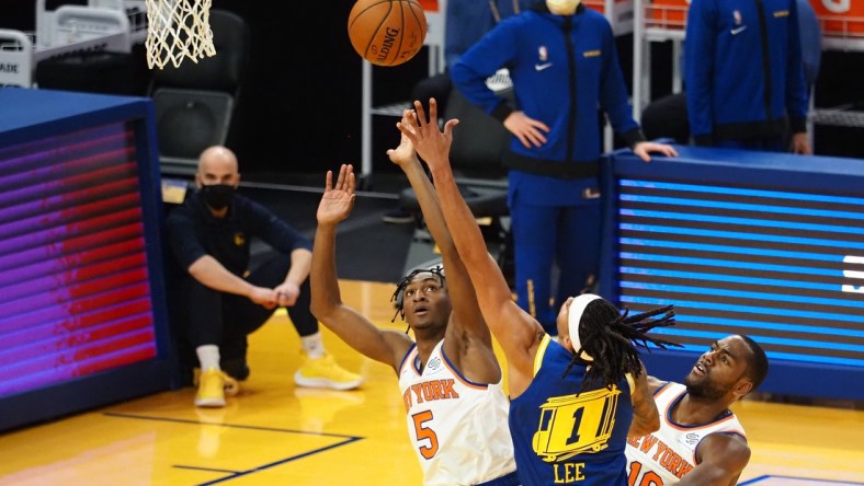 Jan 21, 2021; San Francisco, California, USA; Golden State Warriors guard-forward Damion Lee (1) shoots the ball between New York Knicks guard Immanuel Quickley (5) and guard Alec Burks (18) during the second quarter at Chase Center. Mandatory Credit: Kelley L Cox-USA TODAY Sports