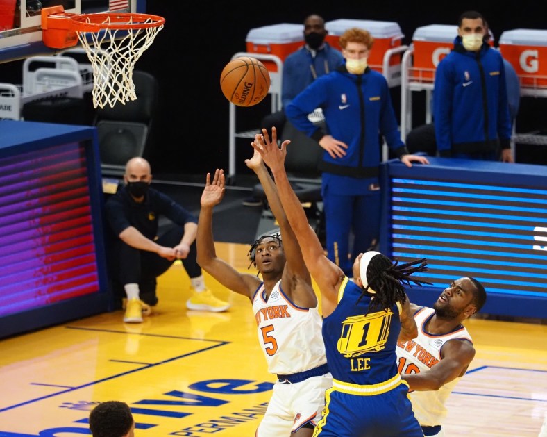 Jan 21, 2021; San Francisco, California, USA; Golden State Warriors guard-forward Damion Lee (1) shoots the ball between New York Knicks guard Immanuel Quickley (5) and guard Alec Burks (18) during the second quarter at Chase Center. Mandatory Credit: Kelley L Cox-USA TODAY Sports