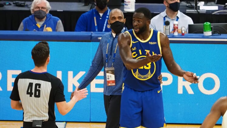 Jan 21, 2021; San Francisco, California, USA; Golden State Warriors forward Draymond Green (23) reacts as referee Ben Taylor (46) issues him a second technical to eject him from the game as security guard Ralph Walker tries to escort him off the court during the second quarter against the New York Knicks at Chase Center. Mandatory Credit: Kelley L Cox-USA TODAY Sports