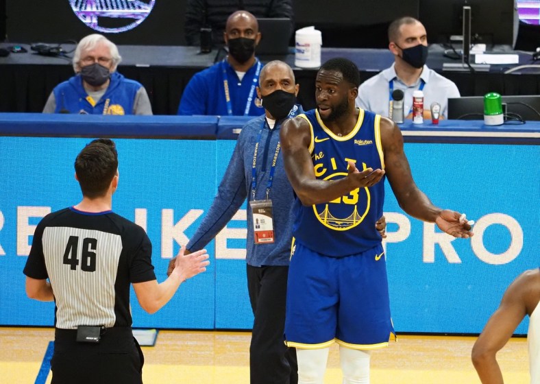 Jan 21, 2021; San Francisco, California, USA; Golden State Warriors forward Draymond Green (23) reacts as referee Ben Taylor (46) issues him a second technical to eject him from the game as security guard Ralph Walker tries to escort him off the court during the second quarter against the New York Knicks at Chase Center. Mandatory Credit: Kelley L Cox-USA TODAY Sports