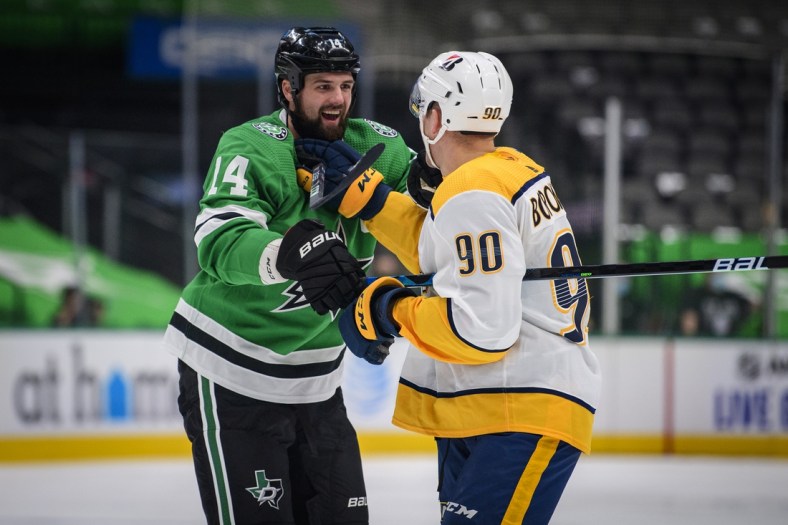 Jan 22, 2021; Dallas, Texas, USA; Dallas Stars left wing Jamie Benn (14) exchanges words with Nashville Predators defenseman Mark Borowiecki (90) during the first period at the American Airlines Center. Mandatory Credit: Jerome Miron-USA TODAY Sports
