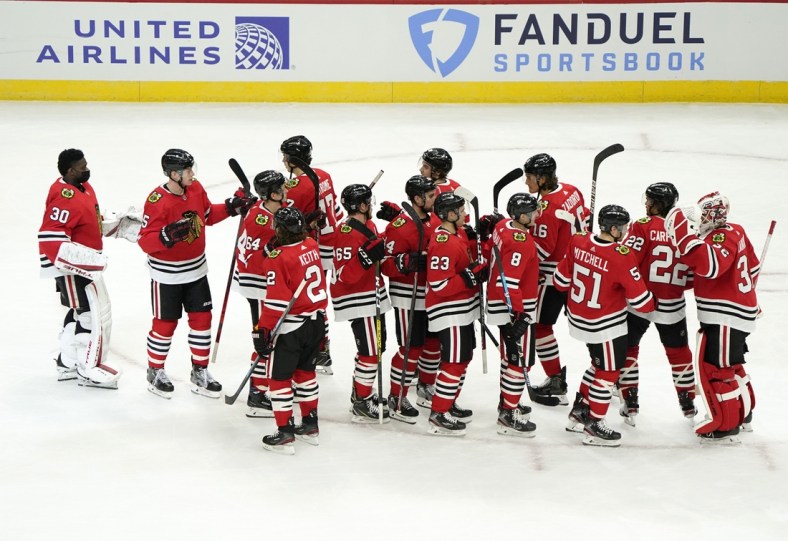 Jan 22, 2021; Chicago, Illinois, USA; The Chicago Blackhawks react after defeating the Detroit Red Wings at the United Center. Mandatory Credit: Mike Dinovo-USA TODAY Sports
