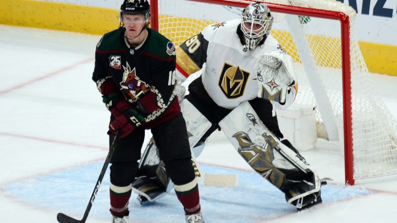 Jan 22, 2021; Glendale, Arizona, USA; Arizona Coyotes center Christian Dvorak (18) screens Vegas Golden Knights goaltender Robin Lehner (90) during the second period at Gila River Arena. Mandatory Credit: Joe Camporeale-USA TODAY Sports