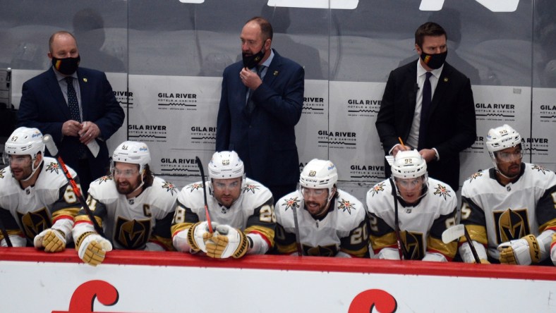 Jan 22, 2021; Glendale, Arizona, USA; Vegas Golden Knights head coach Peter DeBoer (center) looks on against the Arizona Coyotes during the first period at Gila River Arena. Mandatory Credit: Joe Camporeale-USA TODAY Sports